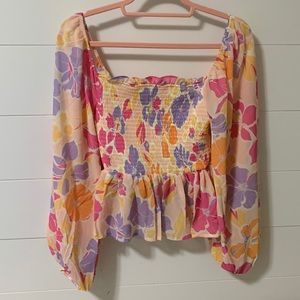 Floral print smocked long sleeve peplum blouse; size Small